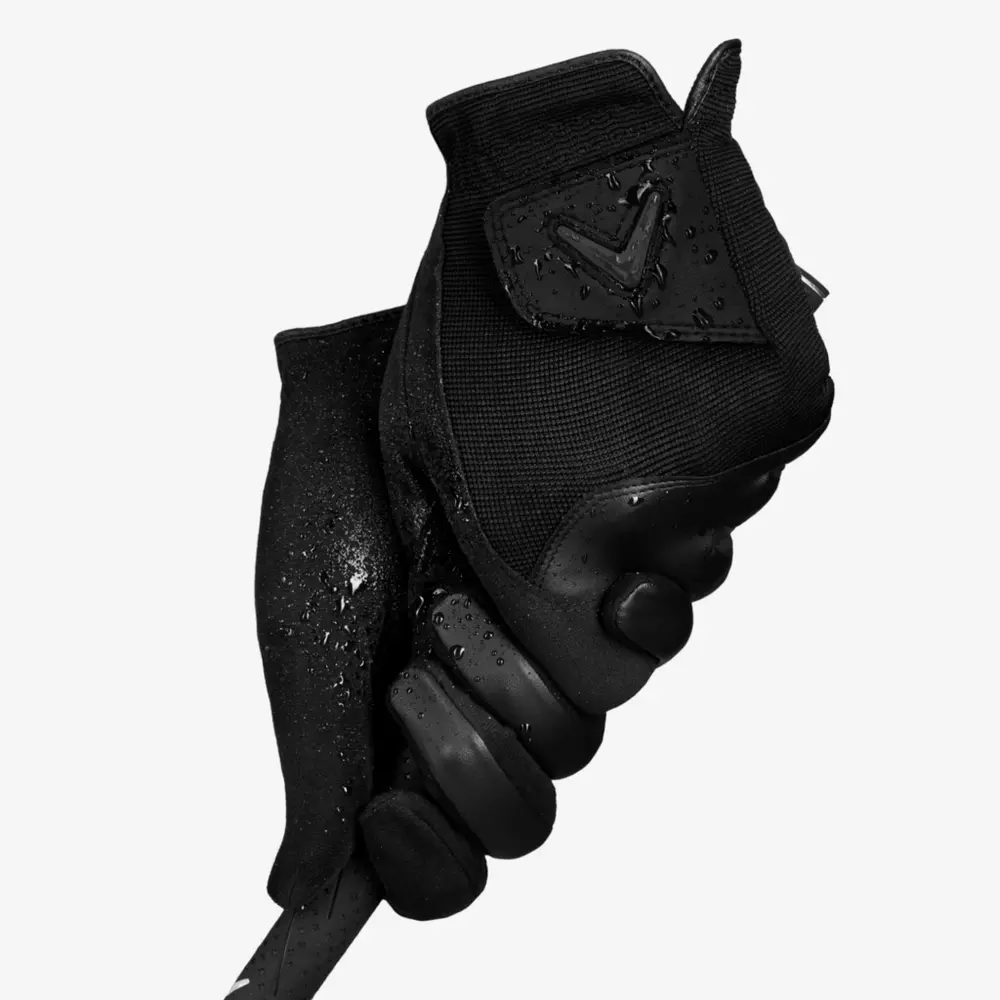 A black glove with water droplets grips a golf club handle, shot against a plain white background&mdash;perfect for highlighting 6 Golf Deals Worth Buying Right Now.