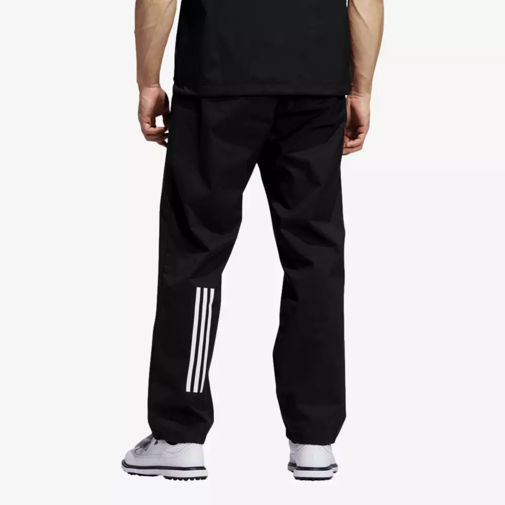 A person wearing black athletic pants with three white stripes on the lower left leg, a black shirt, and white sneakers, shown from the back against a plain background&mdash;perfect for checking out 6 Golf Deals Worth Buying Right Now.