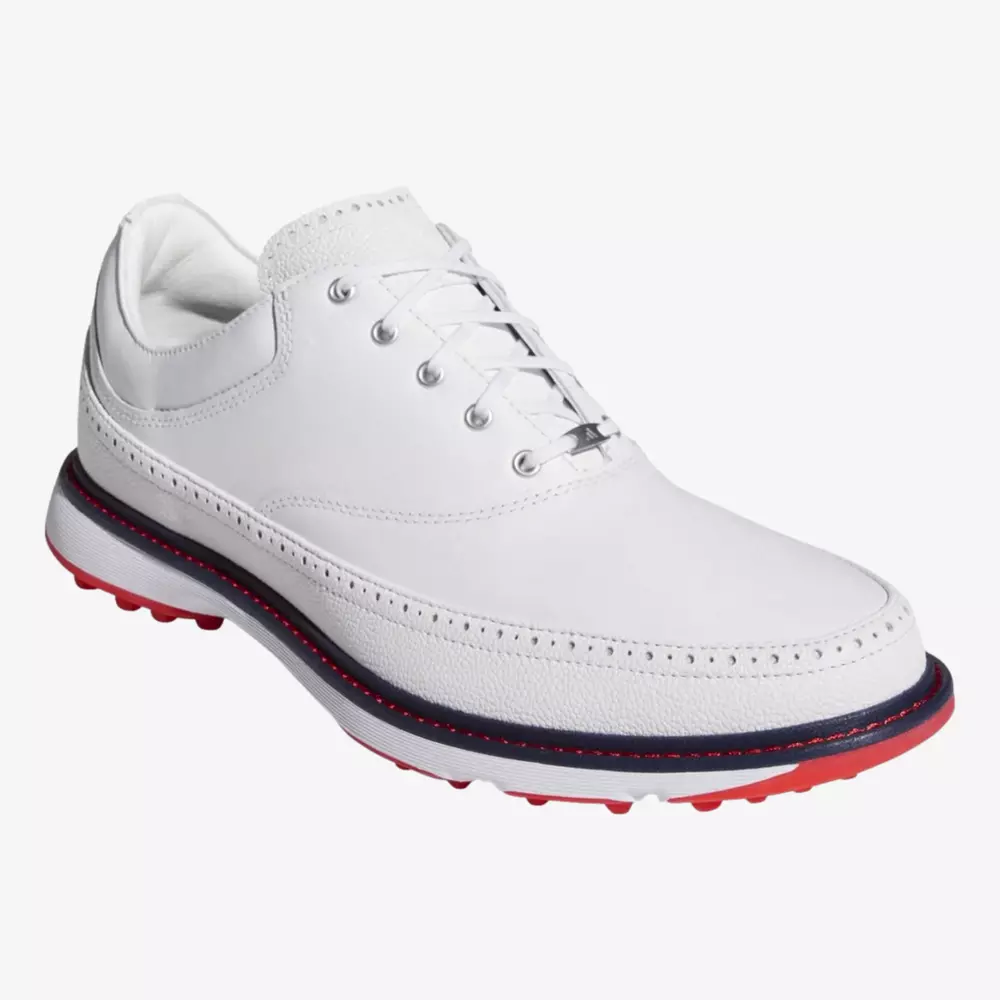 A white leather sneaker with white laces, subtle stitching detail, a dark navy stripe above the sole, and a textured red outsole—perfect for those seeking the best golf deals for around $250. Displayed at an angle on a plain white background.