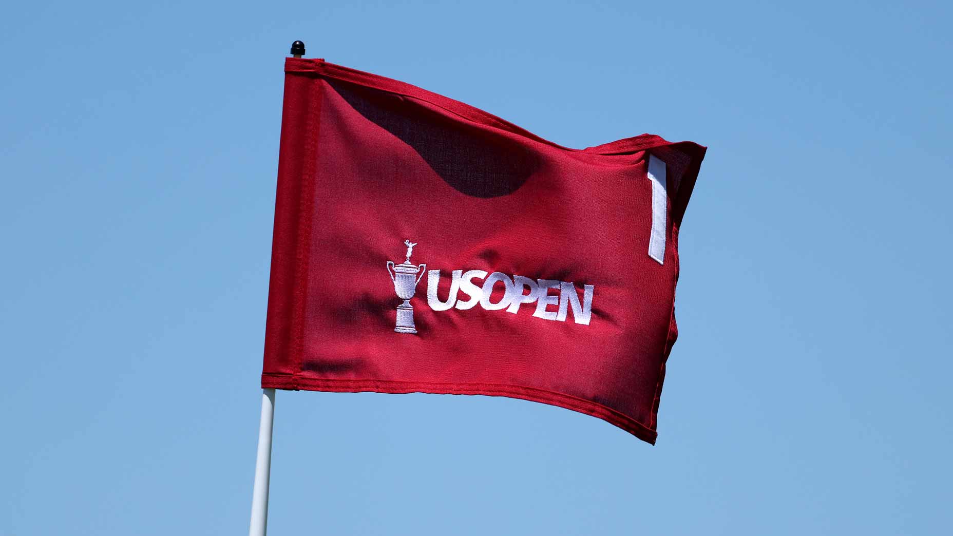 2026 U.S. Open Sunday tee times: Pin flag flaps in wind at Shinnecock Hills.