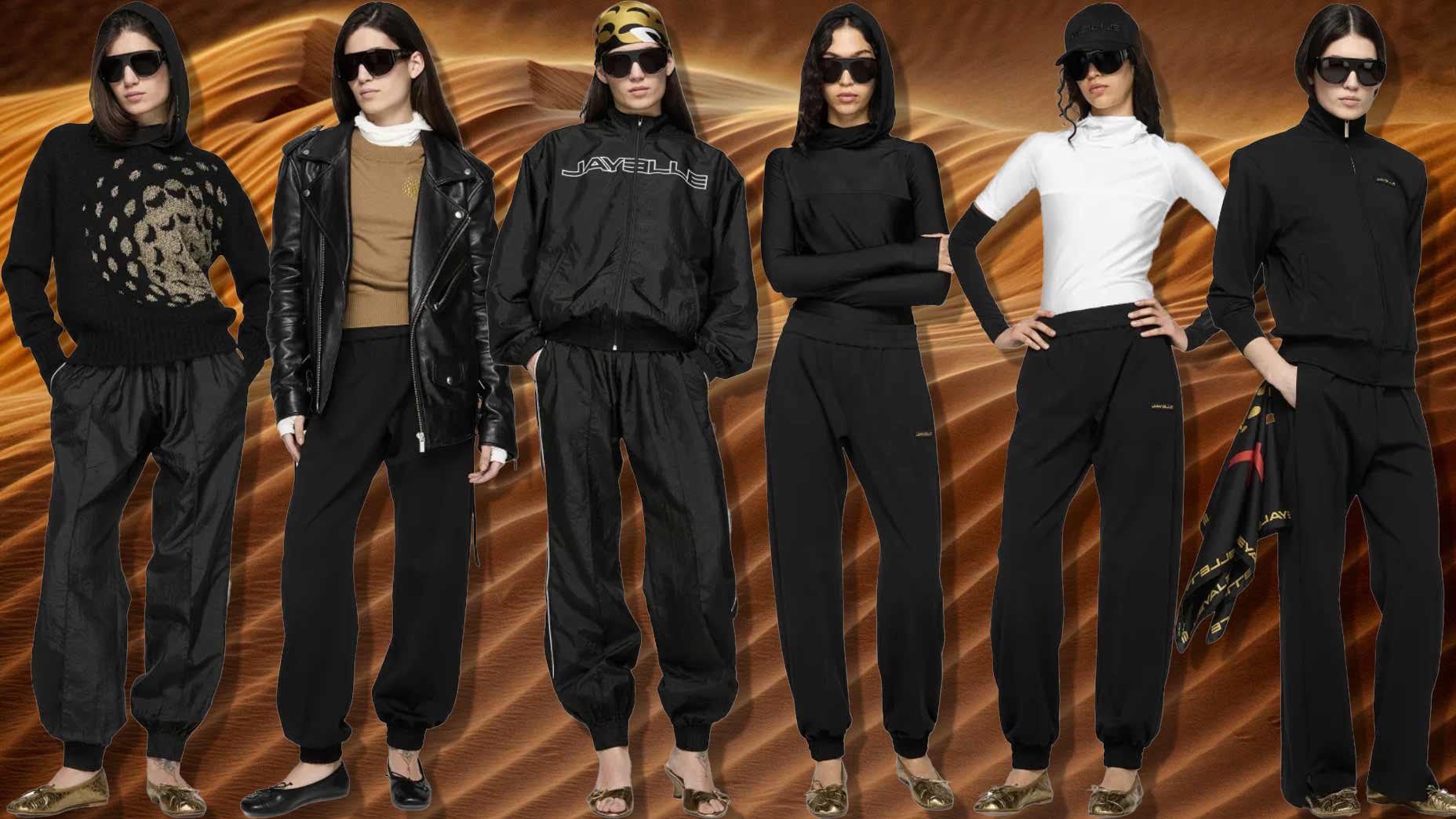 Six women stand in front of a sand dune background, all styled in JAY3LLE black jogger pants with various black or neutral tops—sweaters, jackets, and turtlenecks. They accessorize with sunglasses and some wear hats or headscarves.