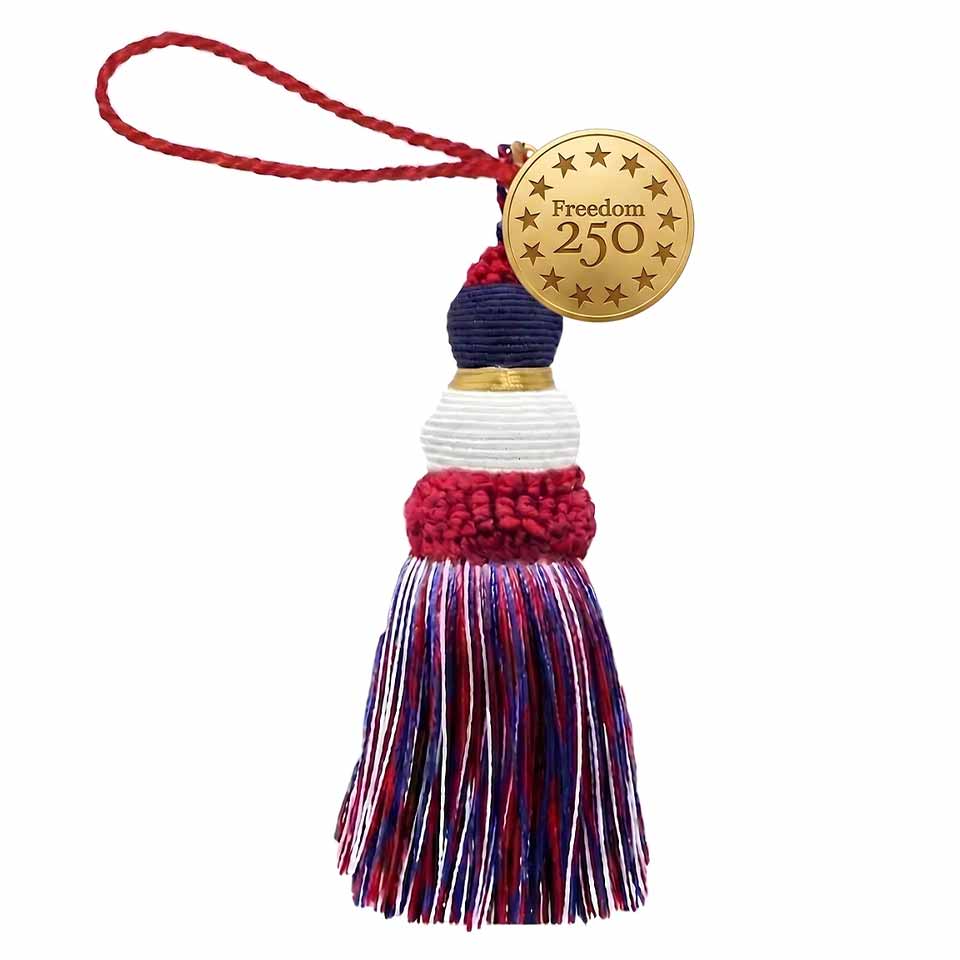 A red, white, and blue tassel ornament with a braided red loop and a gold disc tag that reads Freedom 250 surrounded by stars—perfect to celebrate America and honor America's 250th birthday.