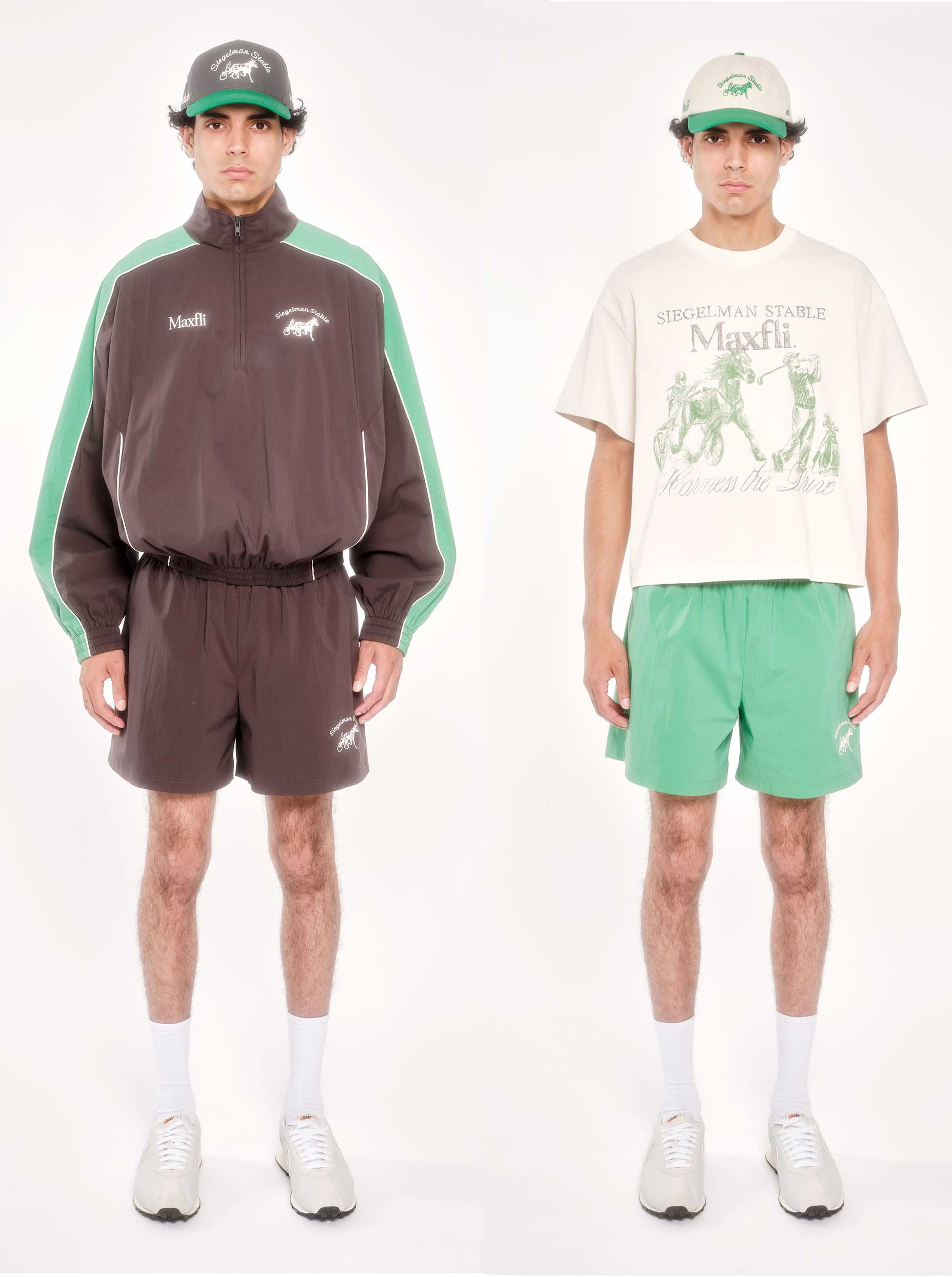Two men stand side by side. The left wears a brown and green jacket with matching shorts and a cap. The right wears a light graphic t-shirt, green shorts, and a cap. Both wear white socks and sneakers, facing forward.