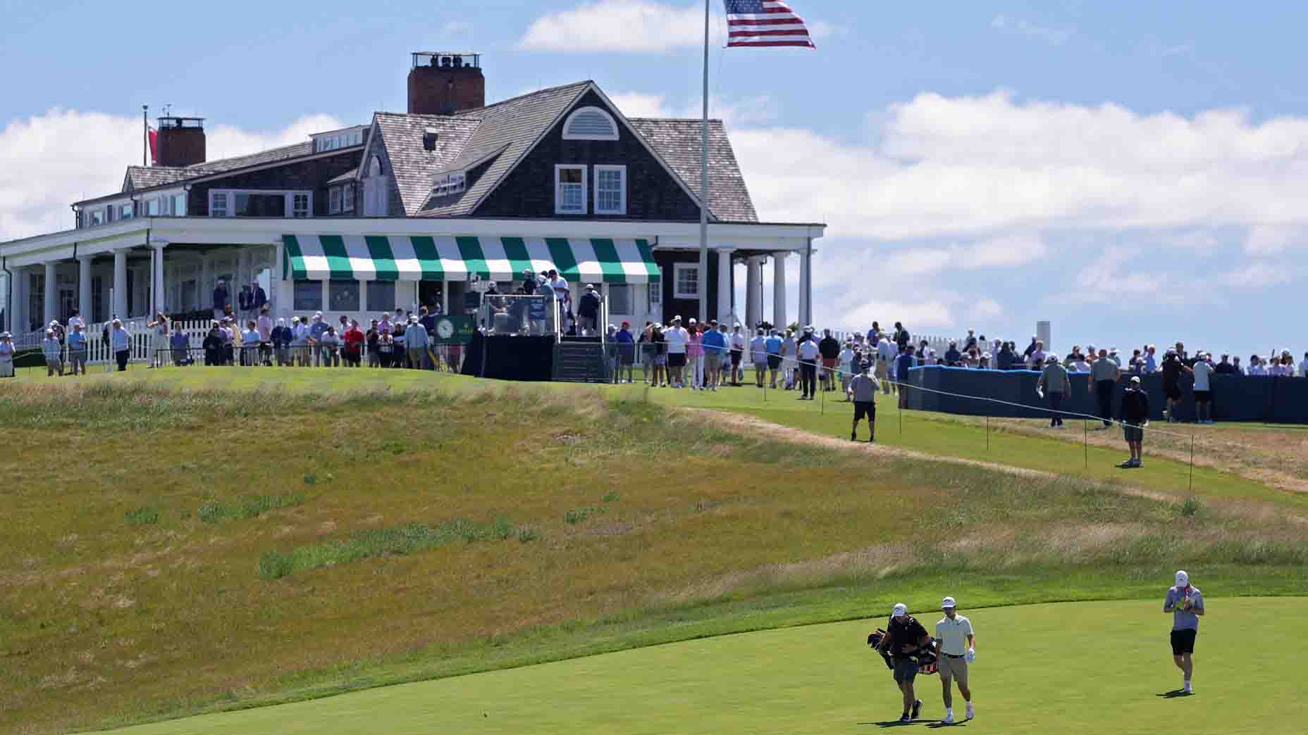 Golfers walk on a fairway at Shinnecock Hills