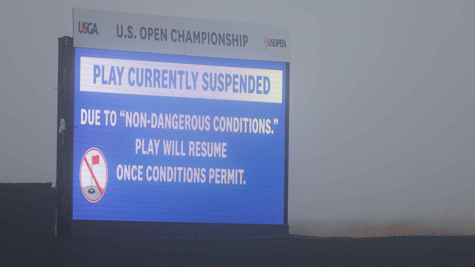 2026 U.S. Open video board seen during fog delay at Shinnecock Hills. A rules debate on TV followed.