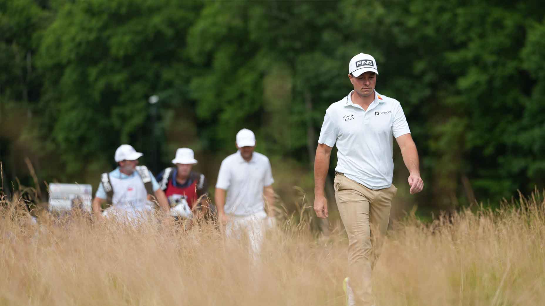 Viktor Hovland and Scottie Scheffler walk during the Travelers Championship