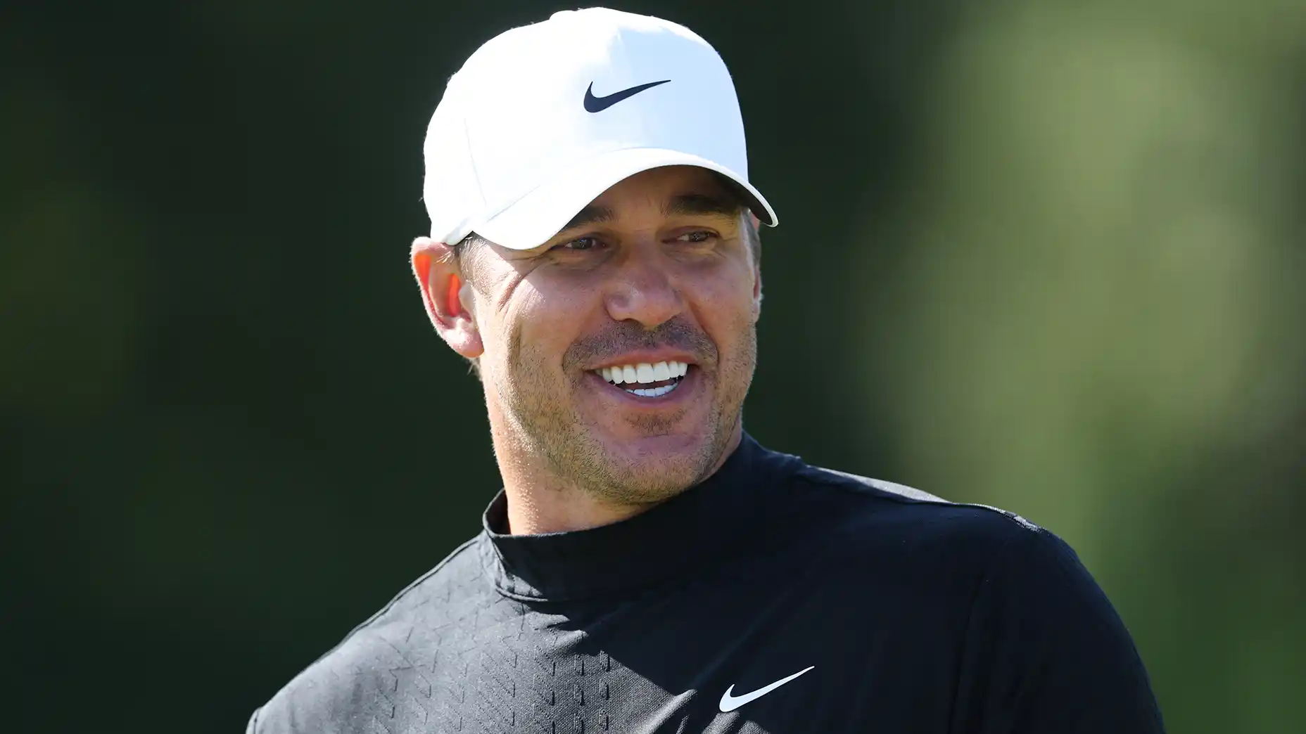 Brooks Koepka smiles during 2026 Genesis Scottish Open