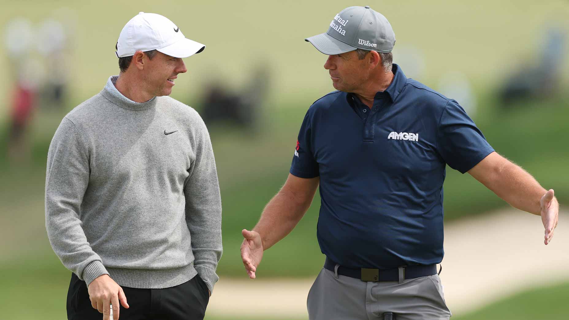 Padraig Harrington and Rory McIlroy talk during a practice round at the 2026 PGA Championship.