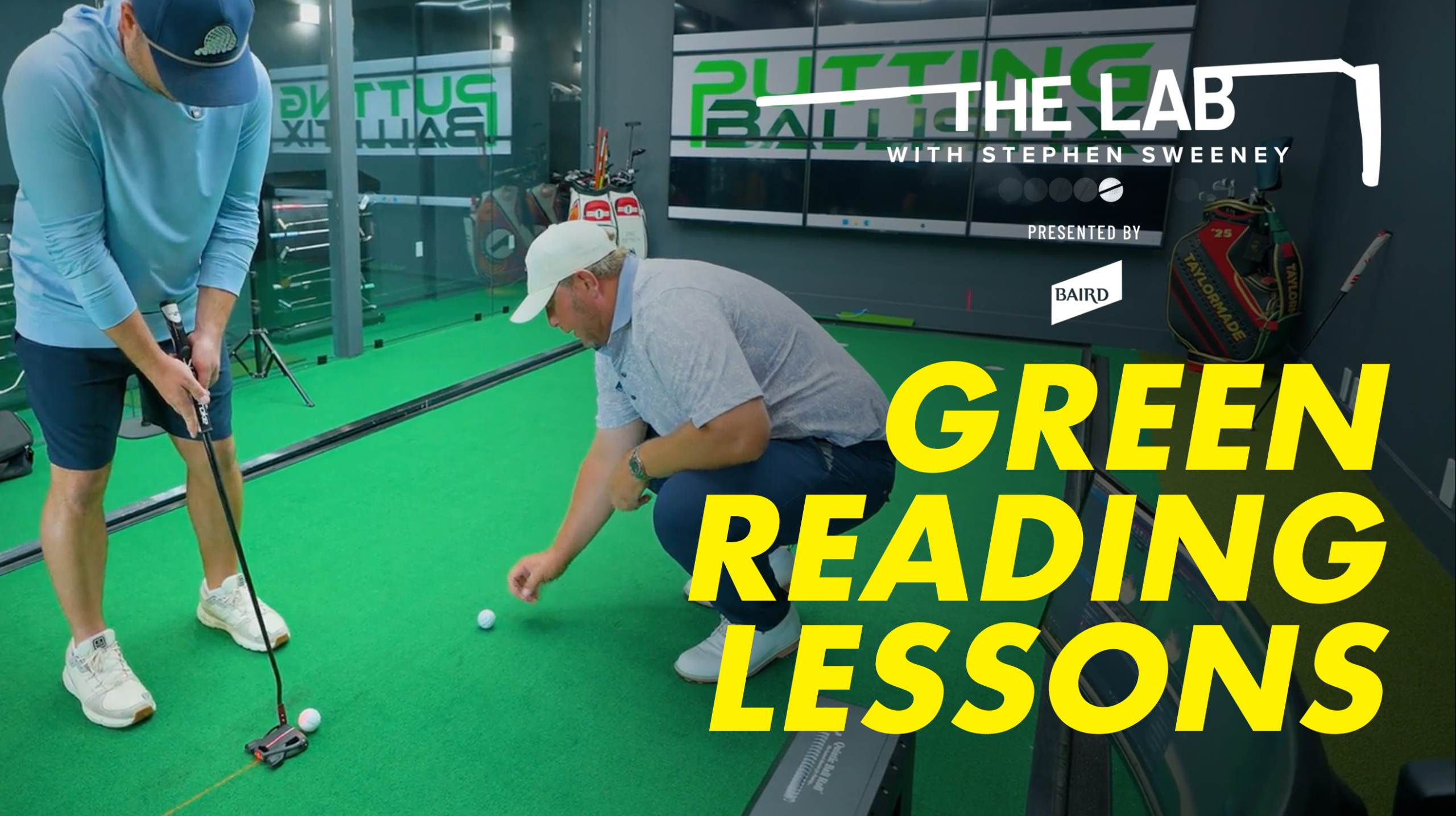 Two men practice putting on an indoor green. One points to a golf ball while the other lines up a putt. Text reads: THE LAB with Stephen Sweeney: Green Reading Lessons. Golf bags and mirrors are in the background.